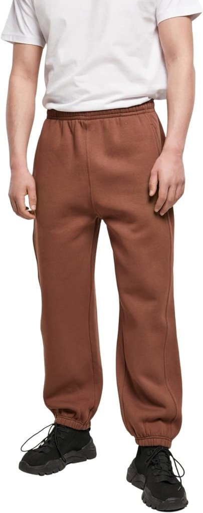 Laad afbeelding in Galerijviewer, Een persoon in een wit t-shirt, comfortabele en stijlvolle joggingbroek voor heren in bruin en zwarte schoenen staat met de handen langs de zijkanten.
