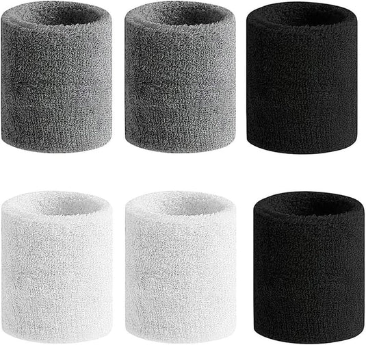 Zes Polsbandjes voor ultieme sportprestaties, ideaal als zweetbandjes, zijn verkrijgbaar in de kleuren grijs, zwart en wit, netjes gerangschikt in twee rijen van drie cilinders.