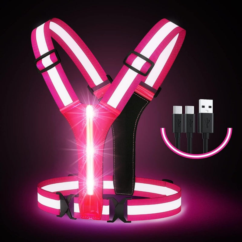 Laad afbeelding in Galerijviewer, Het LED-reflecterende hardloopvest in de kleuren roze en wit, met krachtige LED-verlichting en USB-oplaadpoorten, wordt elegant gepresenteerd tegen een donkere achtergrond voor verbeterde zichtbaarheid en veiligheid tijdens het hardlopen.
