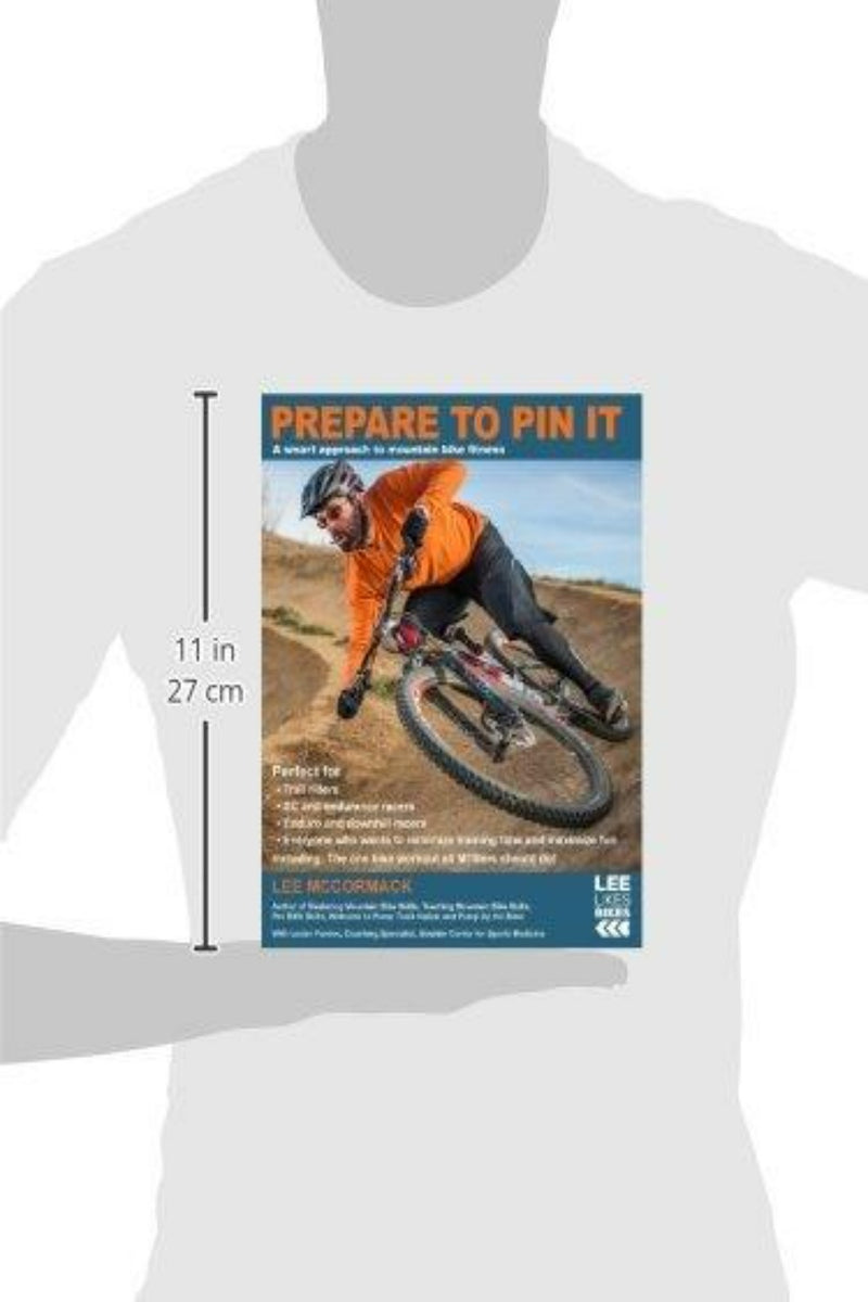 Load image into Gallery viewer, Een persoon draagt een oranje jack en leunt in een bocht terwijl hij op een onverharde weg aan het mountainbiken is. Hij demonstreert de technieken uit &quot;Prepare to Pin It: A smart approach to mountainbike fitness: 2&quot; van Lee McCormack.
